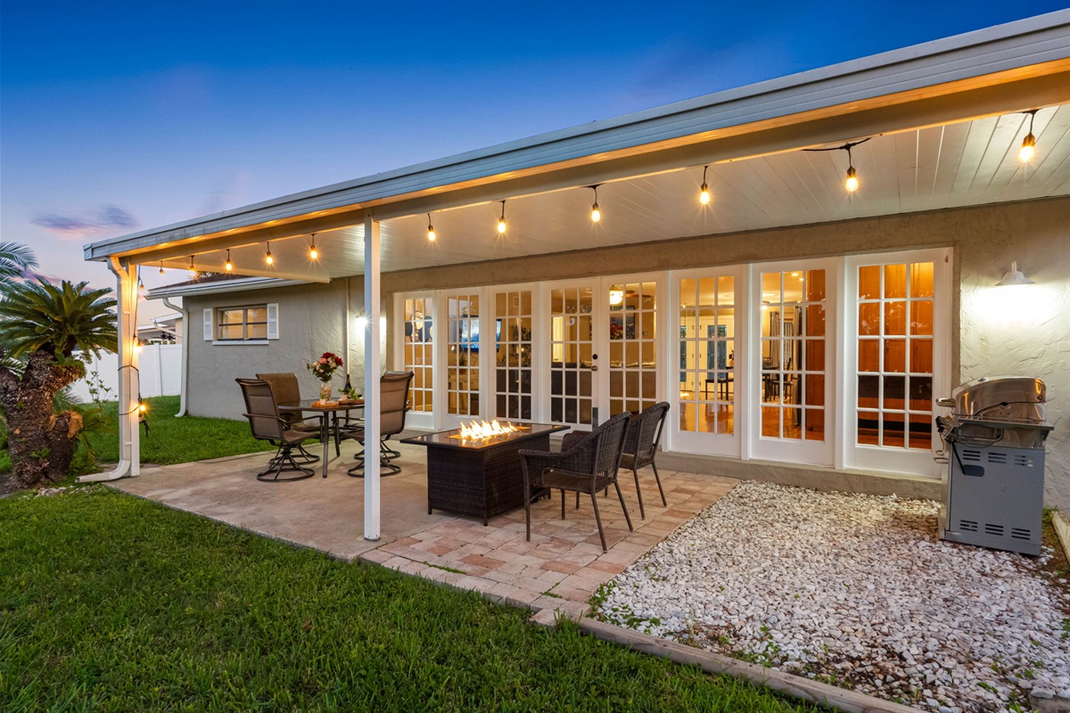 With a spacious dining set and cozy seating around a fire pit, this outdoor area is designed for effortless entertaining and memorable gatherings.