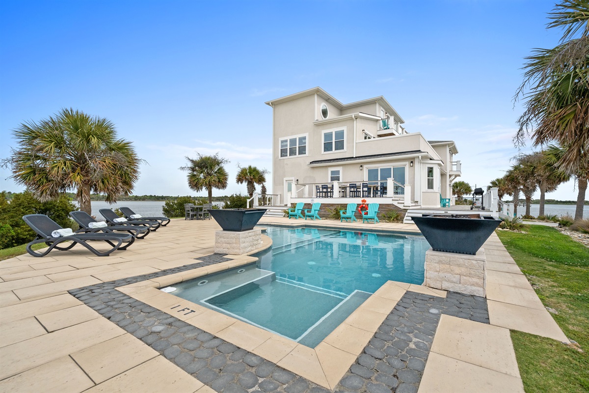 Private waterfront pool with luxury seating and stunning views of the Intracostal Waterway