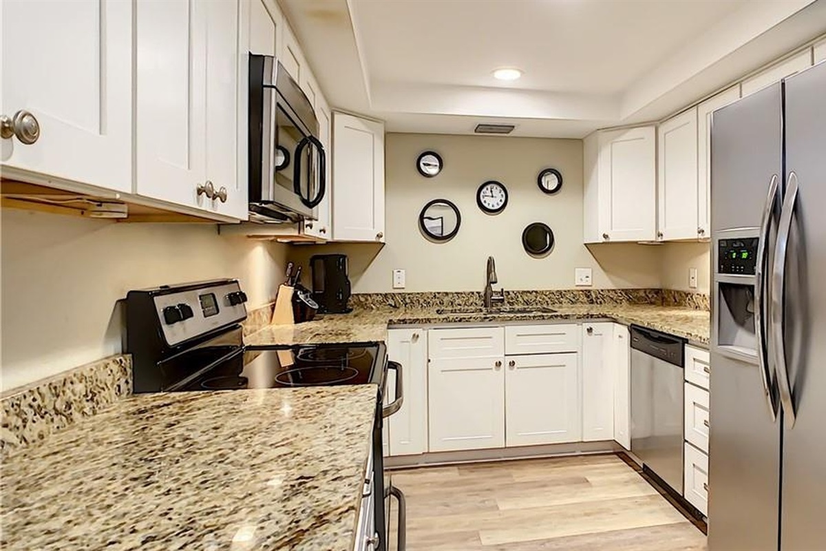 Fully equipped kitchen with stainless-steel appliances, granite counters and a breakfast bar—perfect for cooking fresh seafood from John's Pass during your midterm stay near Madeira Beach in Seminole.