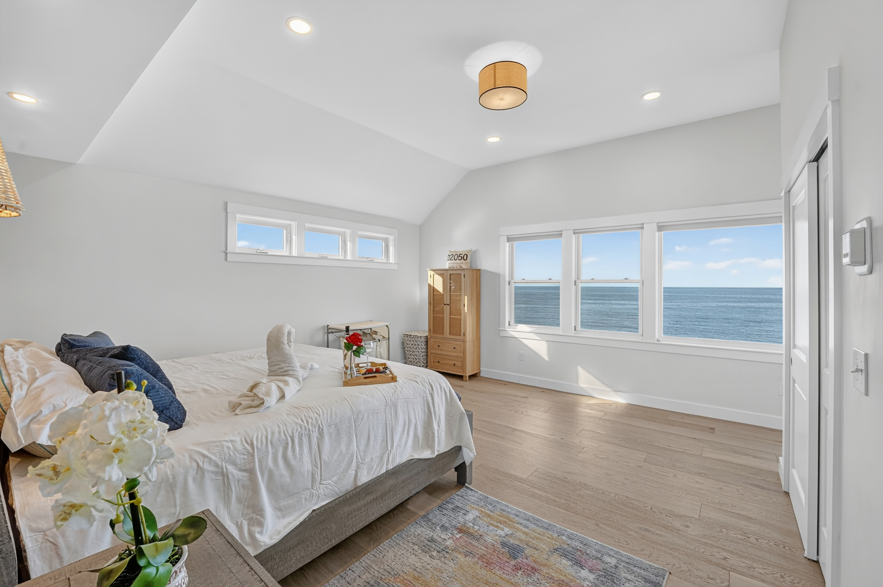 Spacious primary bedroom featuring stunning ocean views and abundant natural light