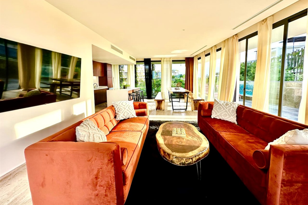 Living room with two central facing couches, and a flat screen TV