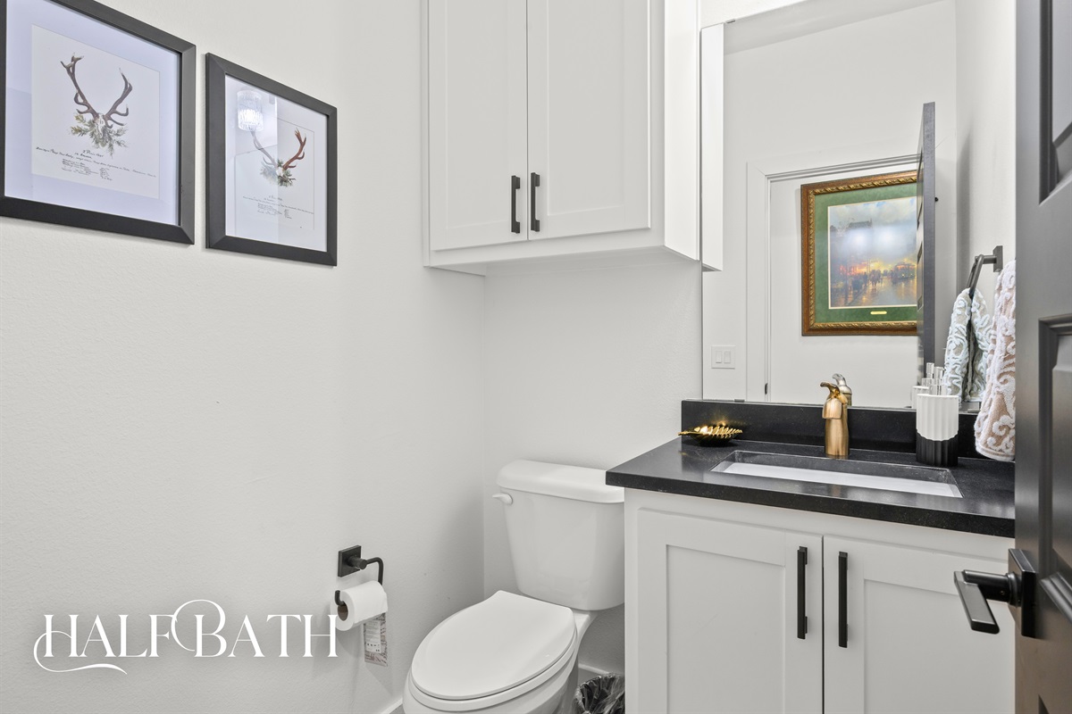 Conveniently located on the main level, the half bath features modern finishes and easy access for guests.