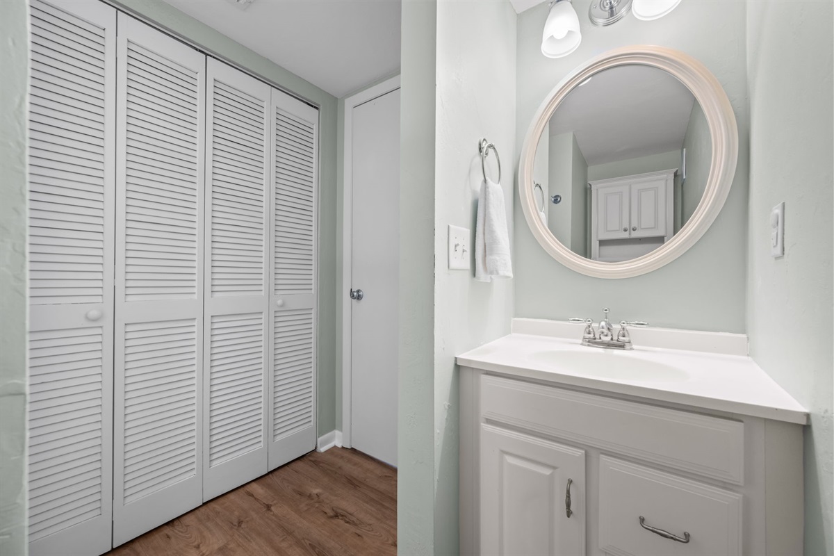 Ensuite bathroom with clean vanity and ample storage space