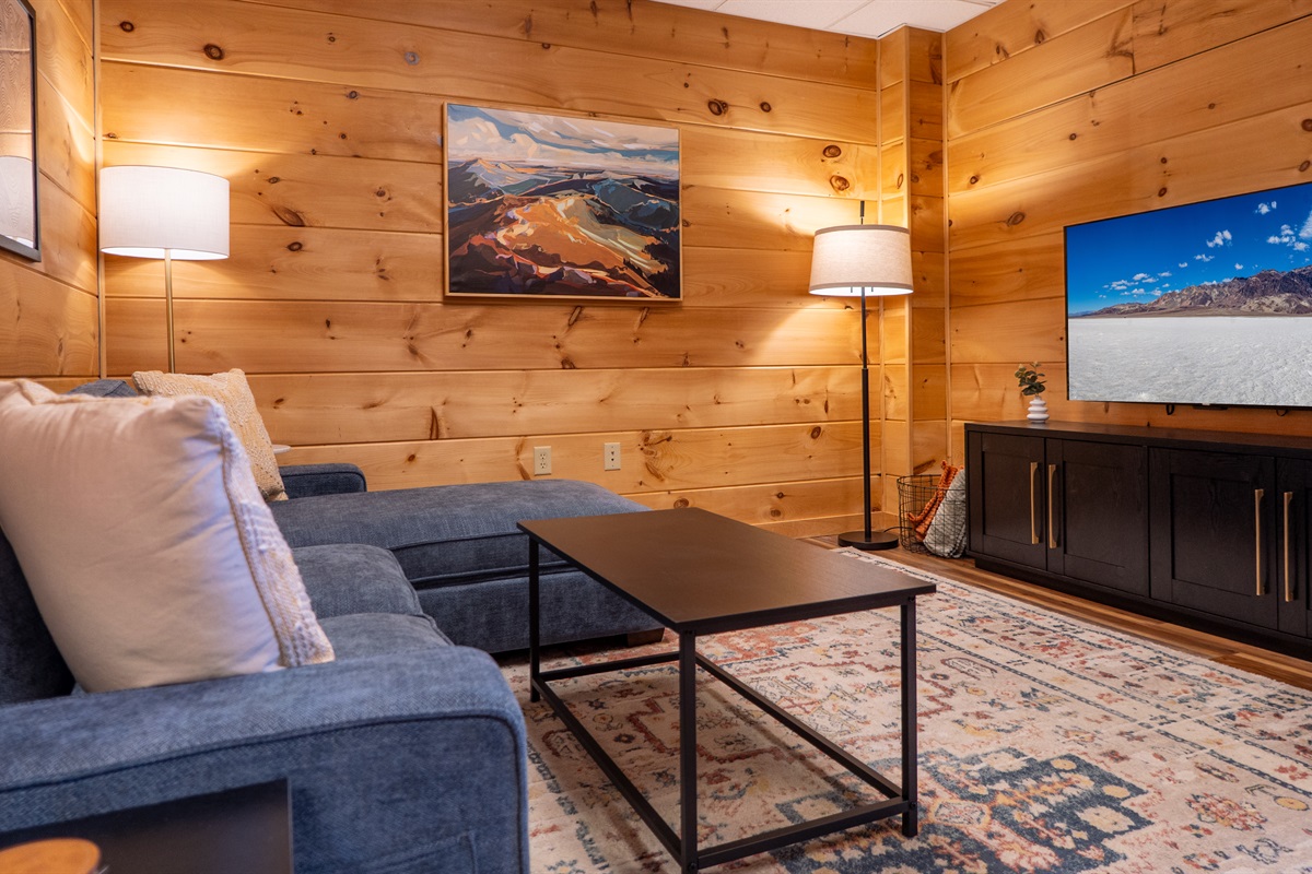 Comfortable and inviting, the lower level living room offers a perfect spot to gather and enjoy time together.