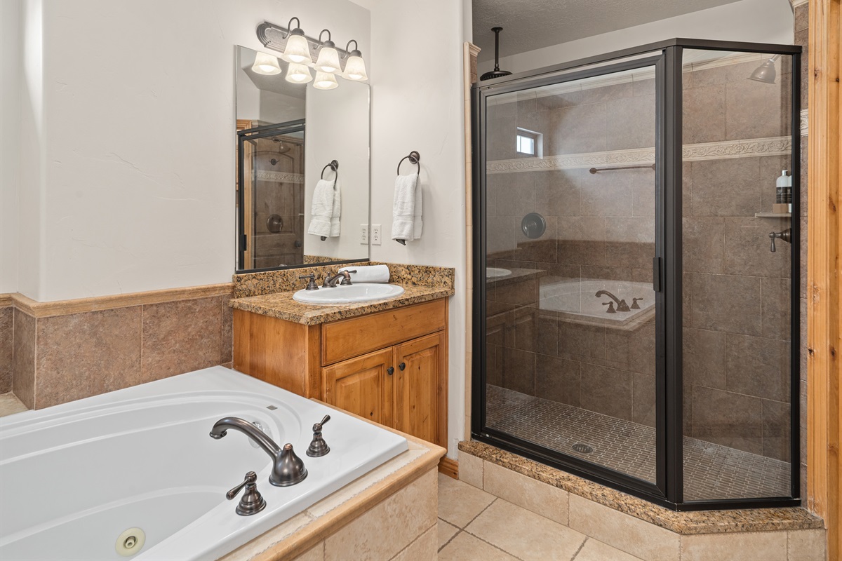 Bathroom with tub and separate glass shower