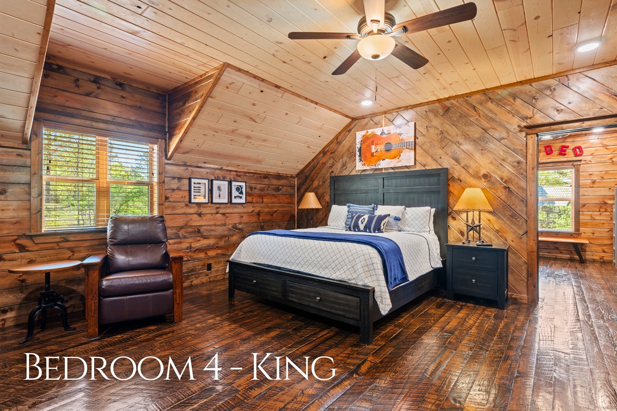This upstairs bedroom offers a quiet and comfortable retreat, complete with warm wood tones and plush bedding that invite you to settle in and recharge.