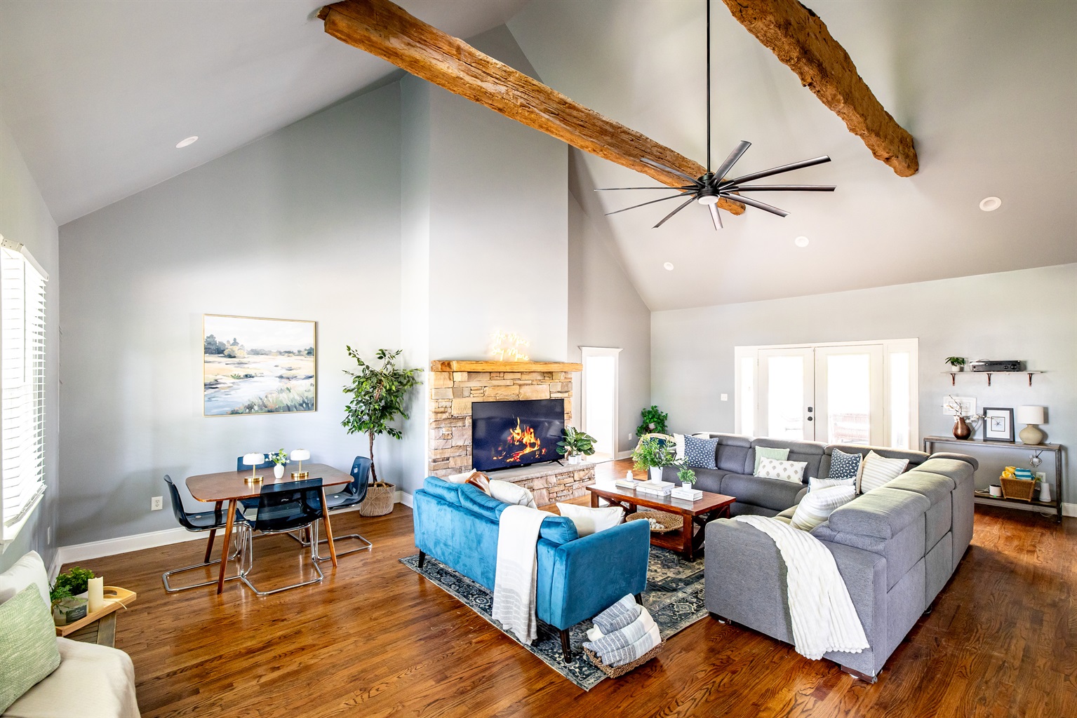 Spacious living room with vaulted ceilings, game table, TV