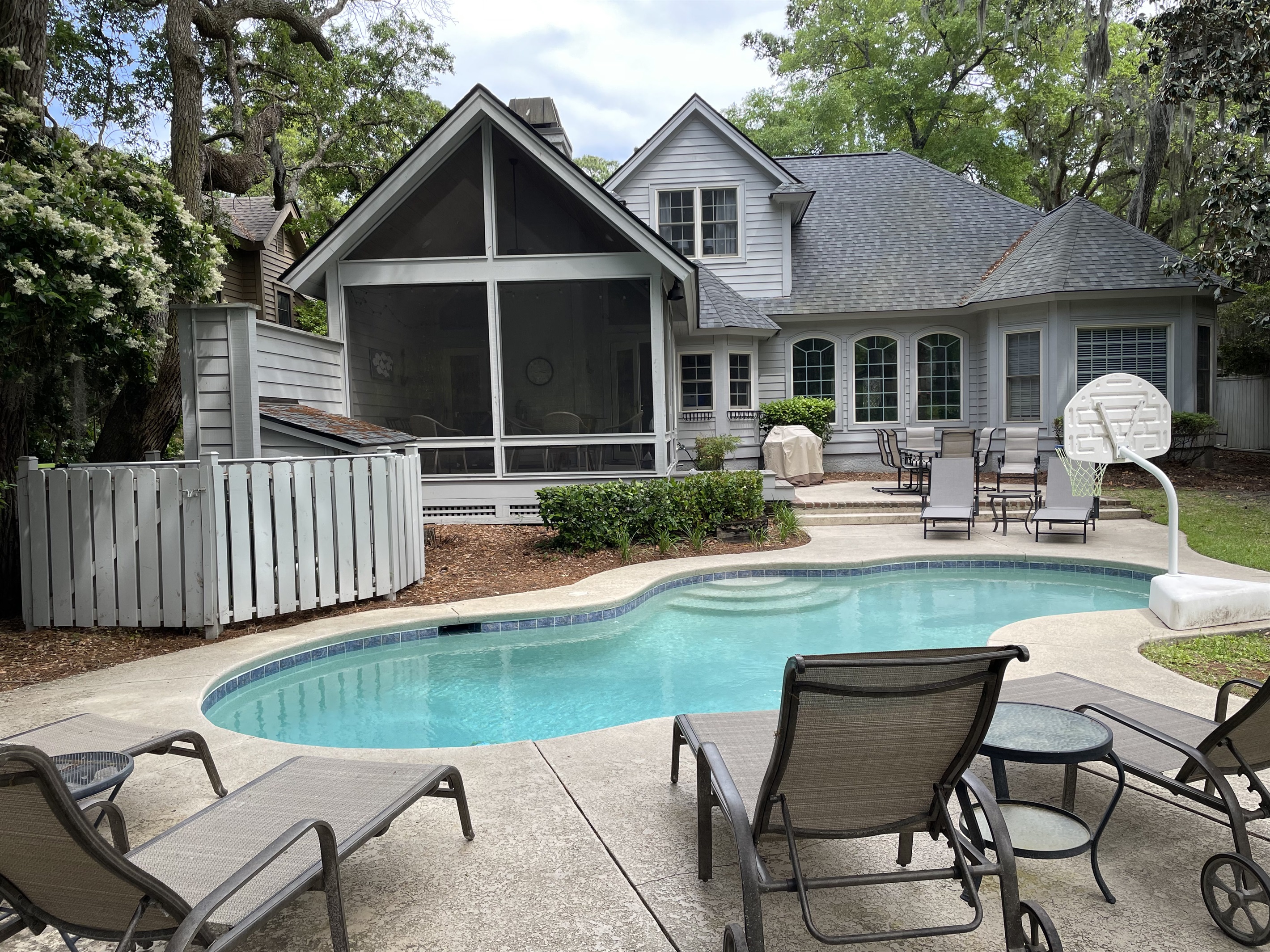 View of house and screen porch from backyard