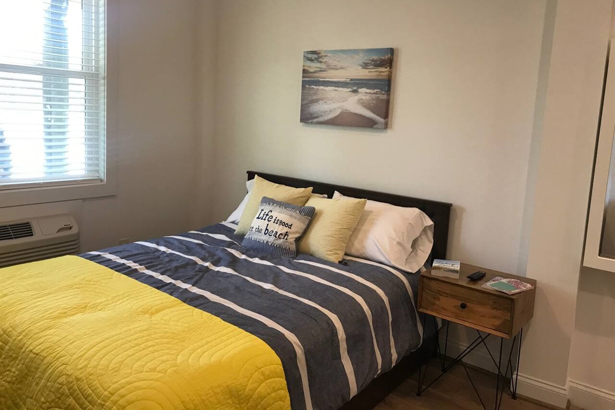 Queen bed with memory-foam mattress and underneath storage.