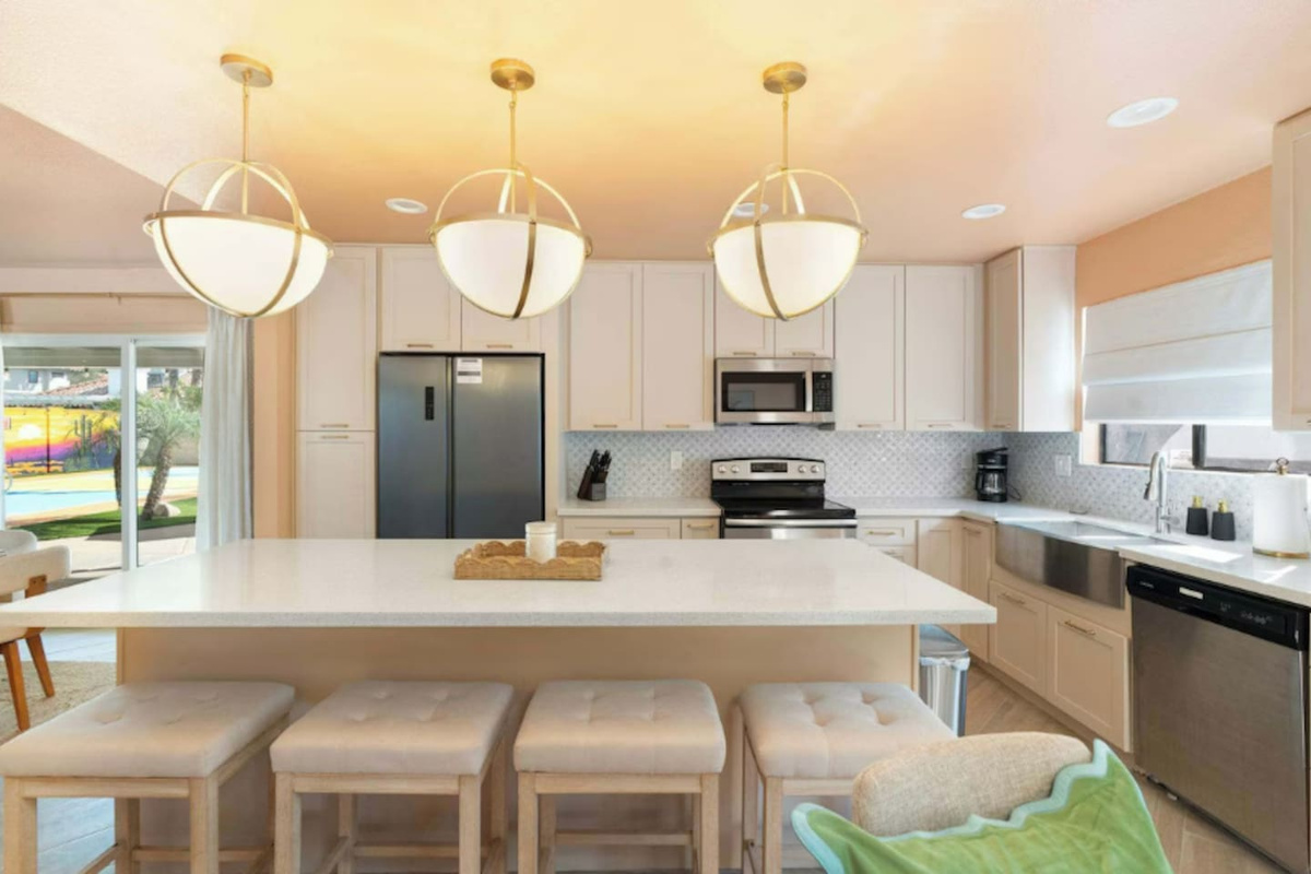 Stainless steel appliances and a farmhouse style sink in this well-equipped kitchen.