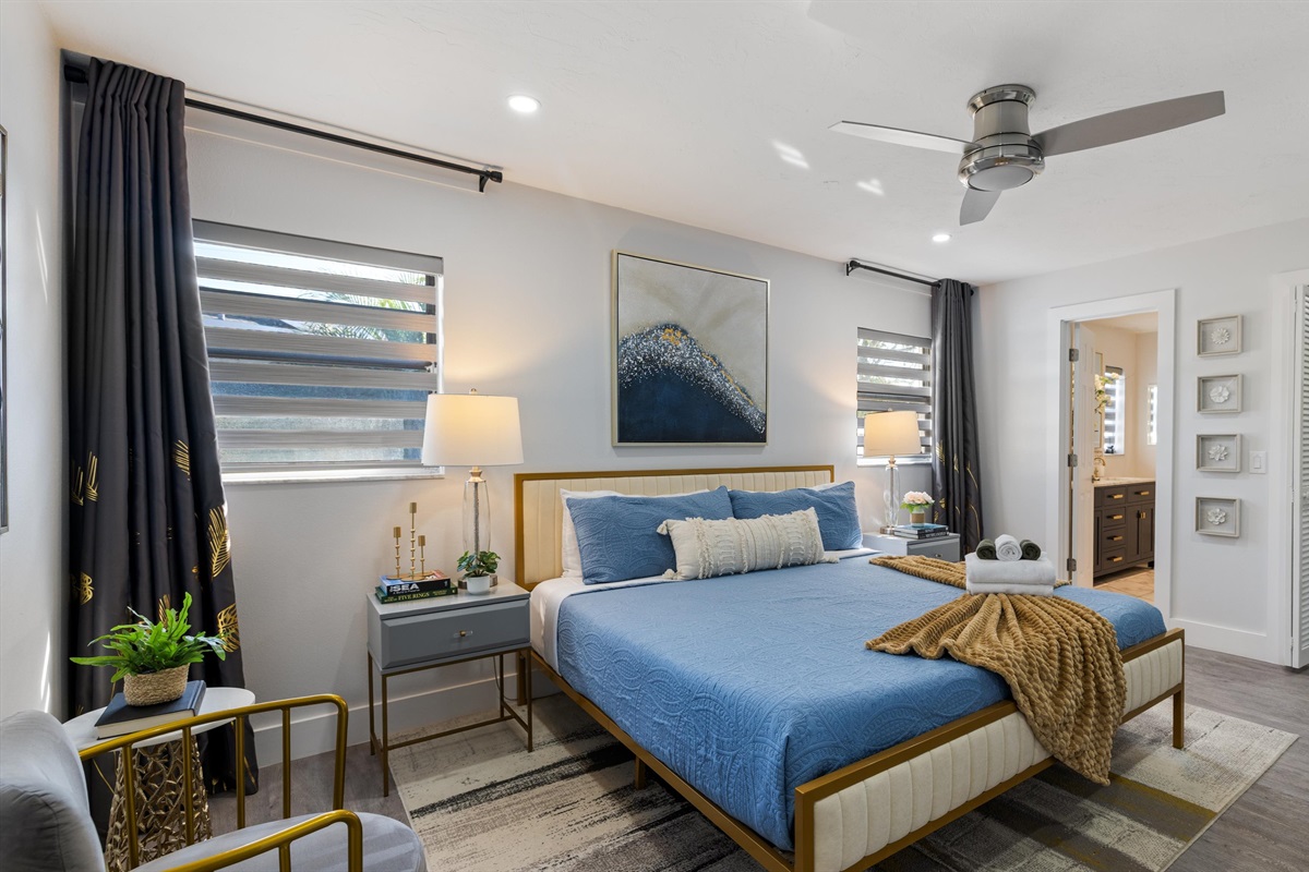 Master Bedroom with a king-size bed, an ensuite bathroom, and a mounted TV.