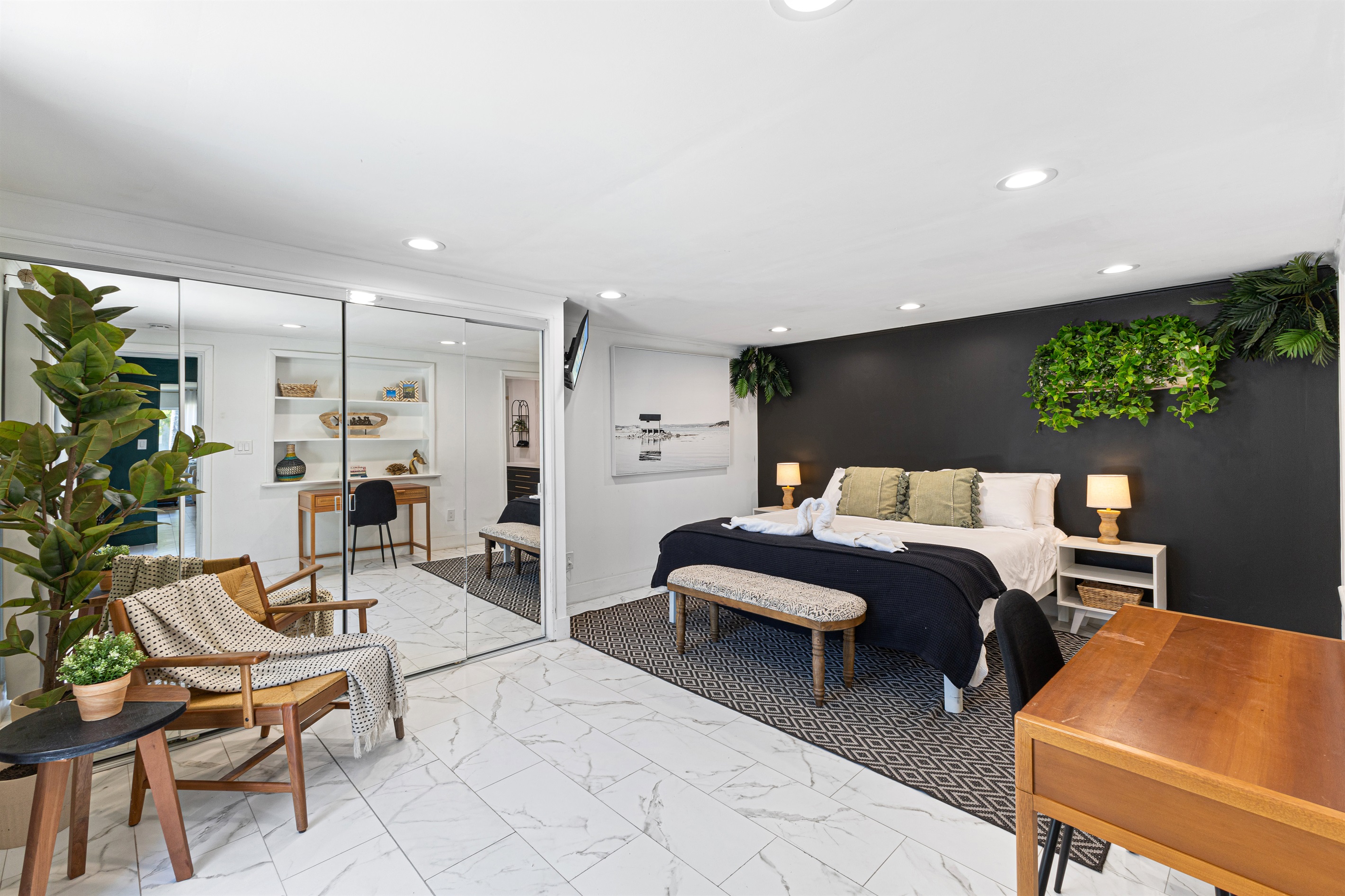 Primary bedroom — private backyard access and cozy work desk.
