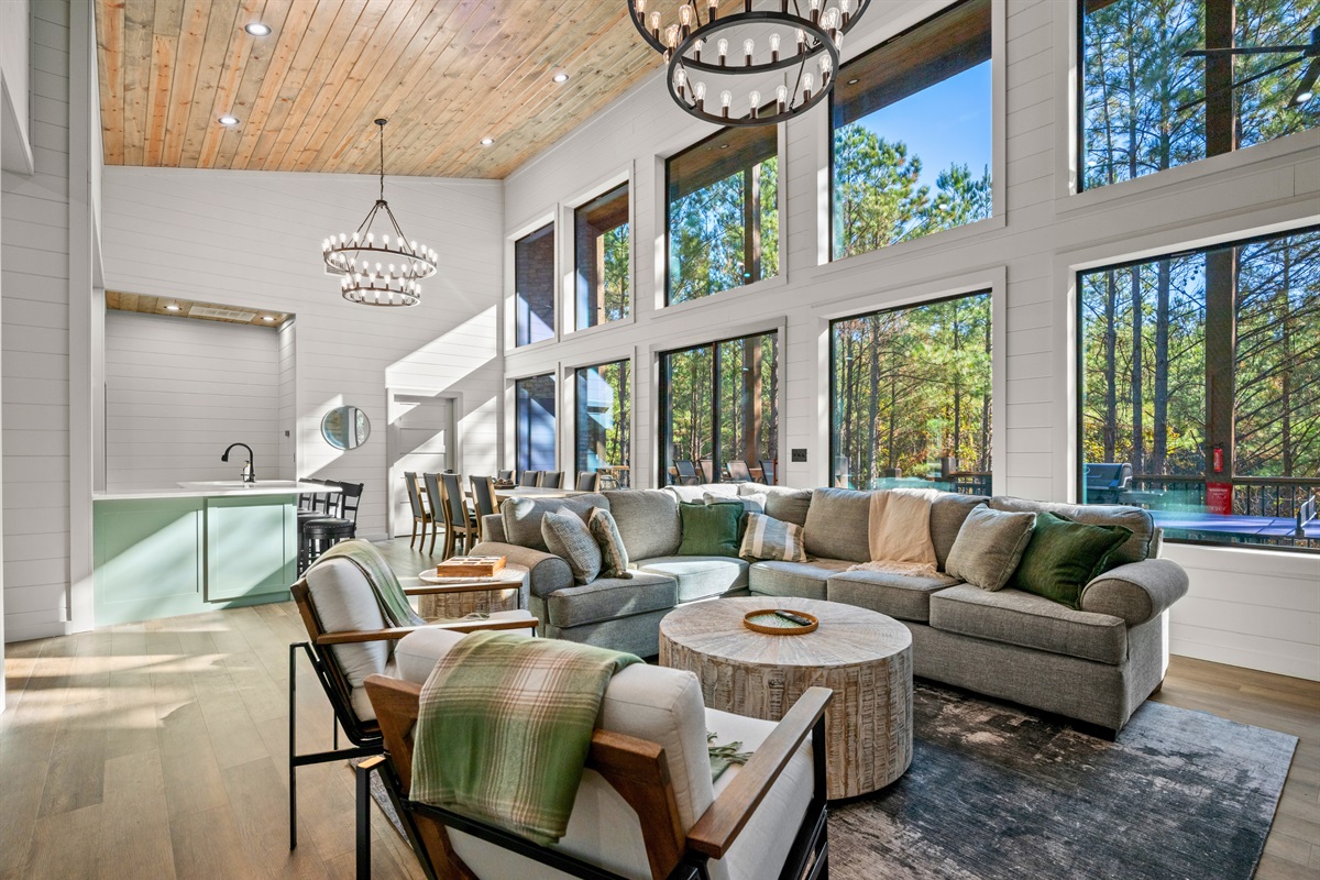 The open-concept living room is filled with natural light and cozy seating, making it the perfect place to unwind, watch a movie, or enjoy time together.