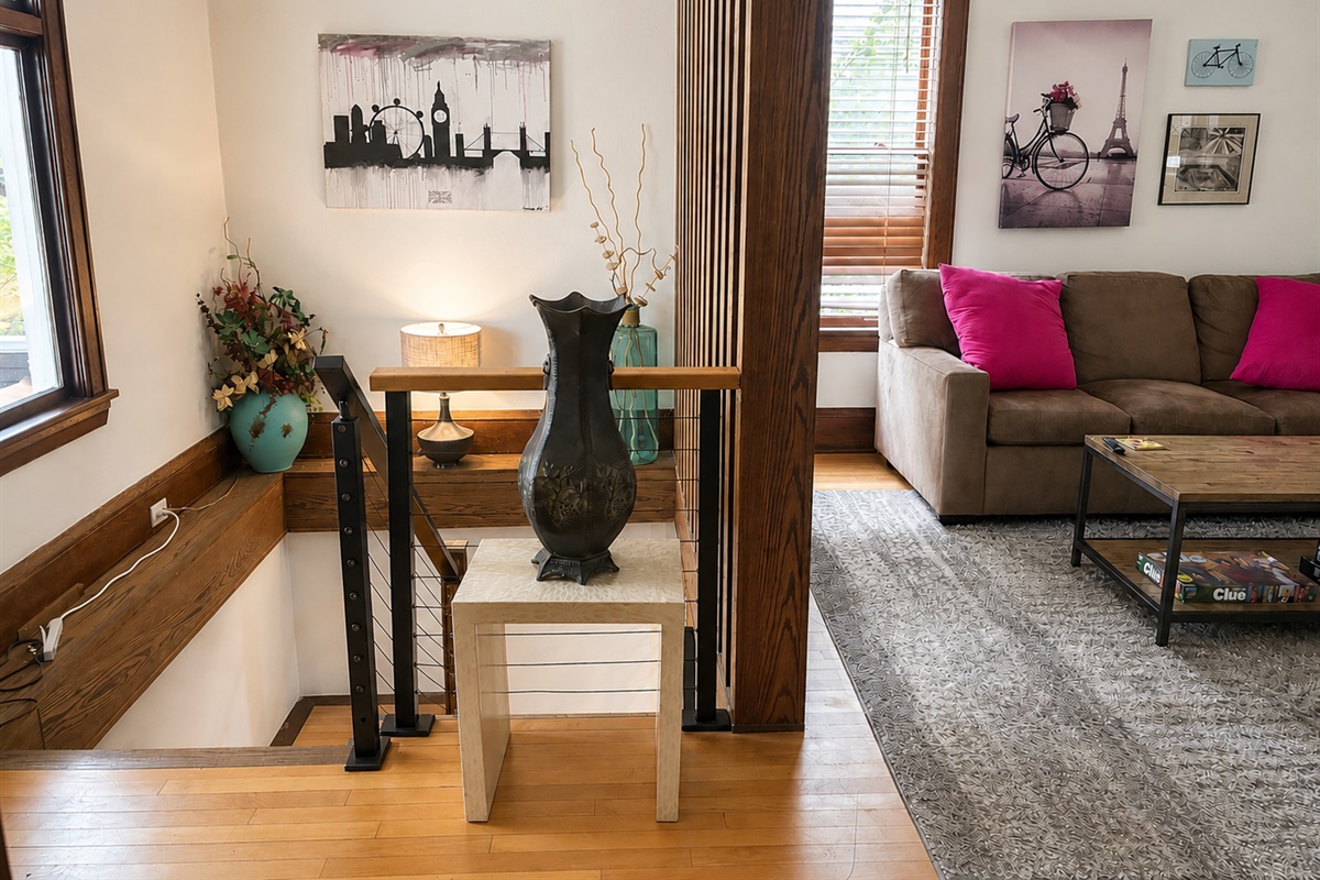 Staircase to the basement apartment area, adjacent to living room. Downstairs apartment area has two other bedrooms, a kitchen and bath. Residents can share an entrance, and can move freely throughout large apartment.