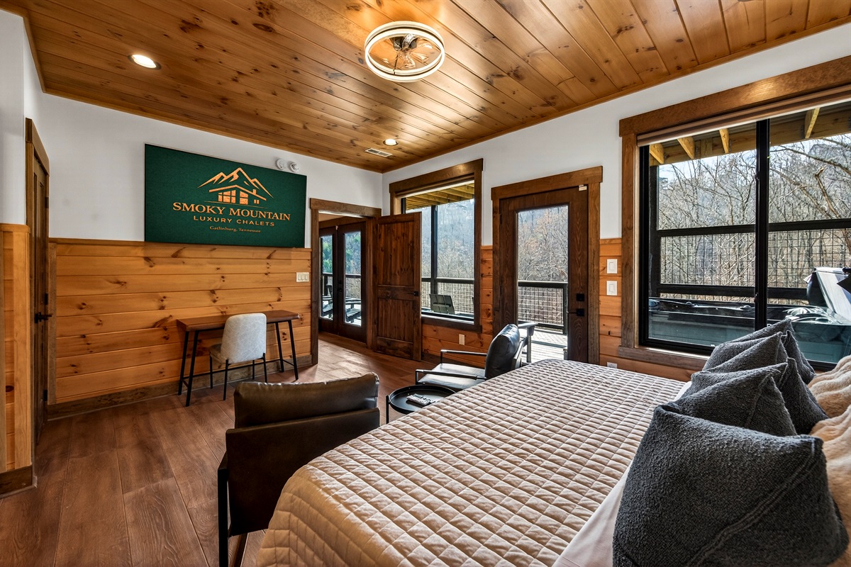 Relax in the spacious king bedroom with a large TV, dedicated desk workspace & direct deck hot tub access. Unwind in the en-suite bathroom featuring a walk-in shower with a natural river rock floor, bringing  the Smoky Mountains indoors for a spa retreat.