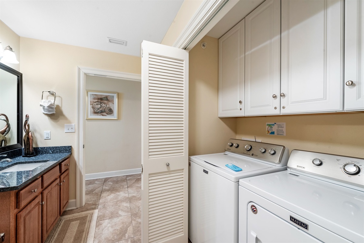 Bathroom with walk in shower and laundry area