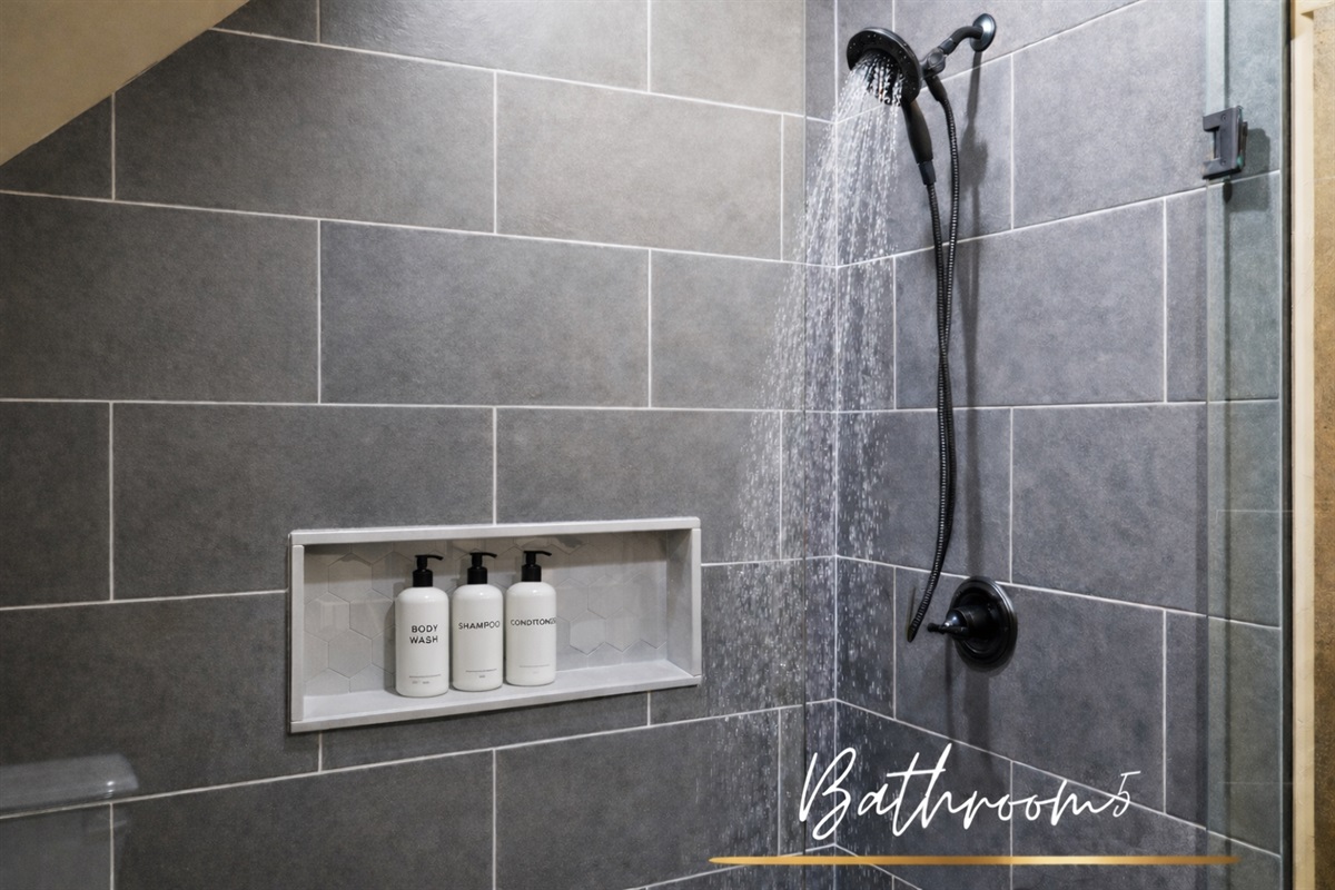 Bathroom 5: A glass-enclosed walk-in shower offers both style and functionality in this beautifully designed bathroom.