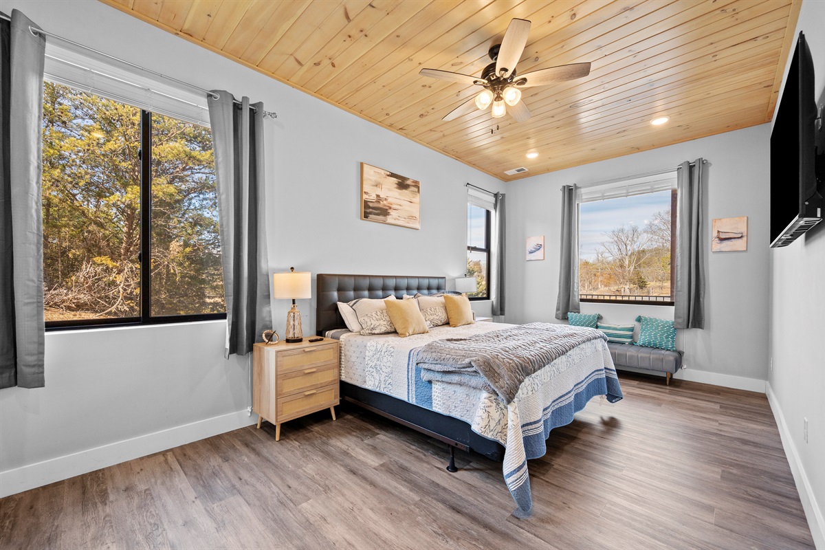 Primary bedroom featuring a comfortable bed, large windows, and calming décor. A peaceful retreat at the end of the day.