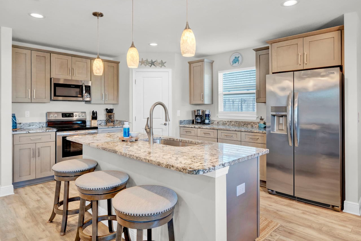 Spacious Kitchen, Stocked with everything you need to make home cooked meals and pack for the beach, we even provide coolers for our guests to use.