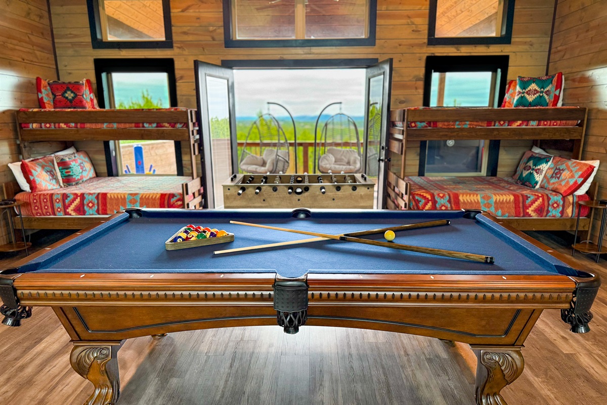 Upstairs bunk room and game room with private deck.