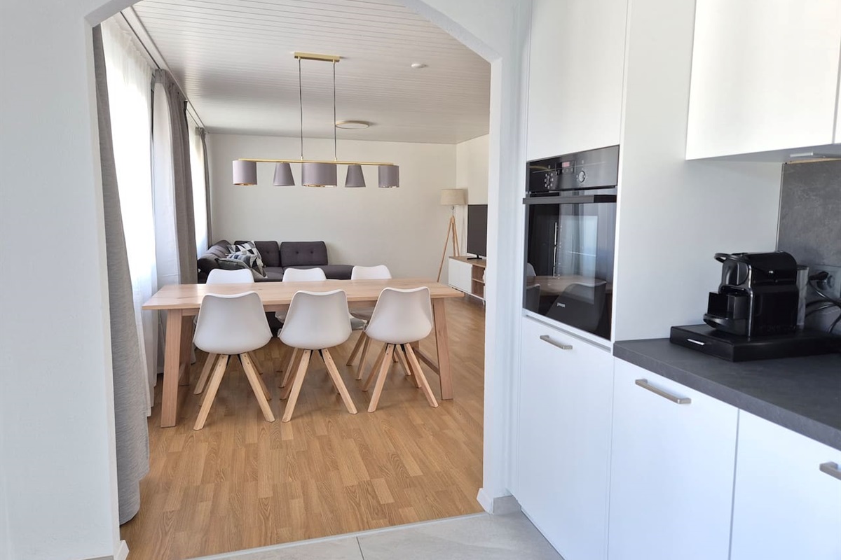 View from the kitchen towards the dining table and living room