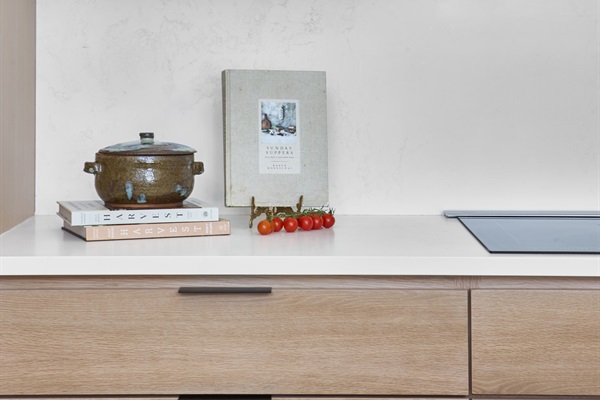 Modern art and natural textures add warmth and personality to this chef’s kitchen.