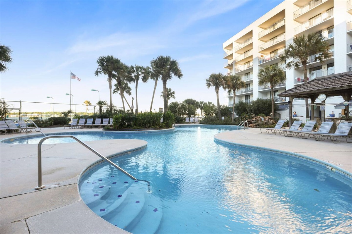 This pool is so inviting! The lounge chairs, umbrella tables, palm trees, and tiki hut make you want to stay all day! 