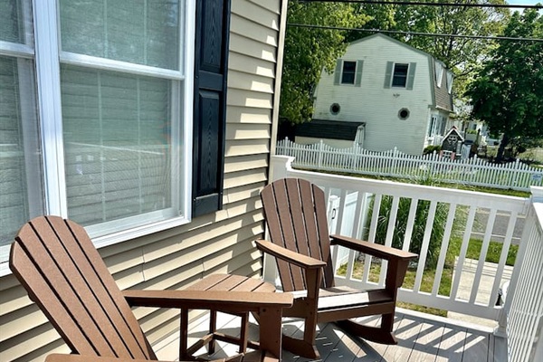 Settle into these classic rocking chairs for a relaxing view of the quiet neighborhood. This cozy front porch nook is a wonderful spot to enjoy a morning breeze or unwind with a book while the world slowly passes by.