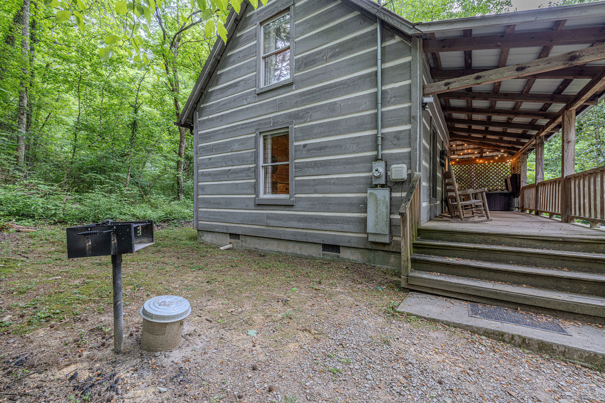 Tucked into the trees with a long covered porch.