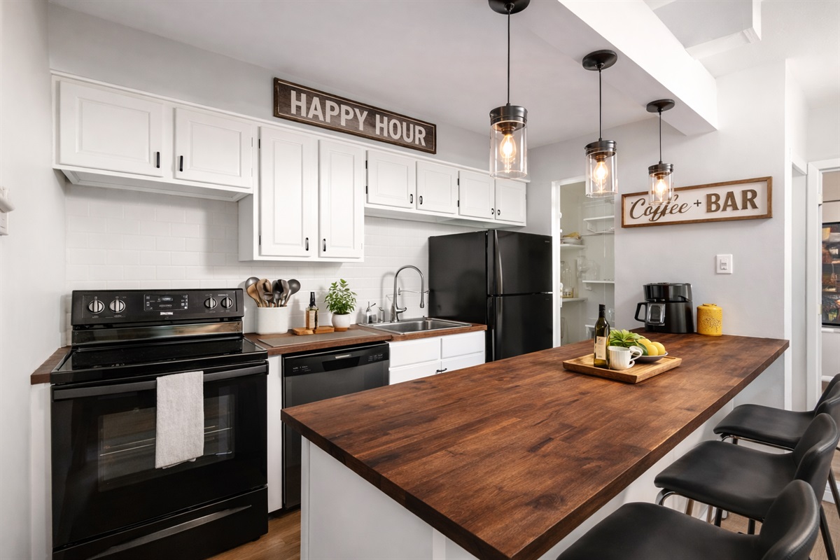 Fully stocked kitchen with breakfast bar seating for the whole crew.