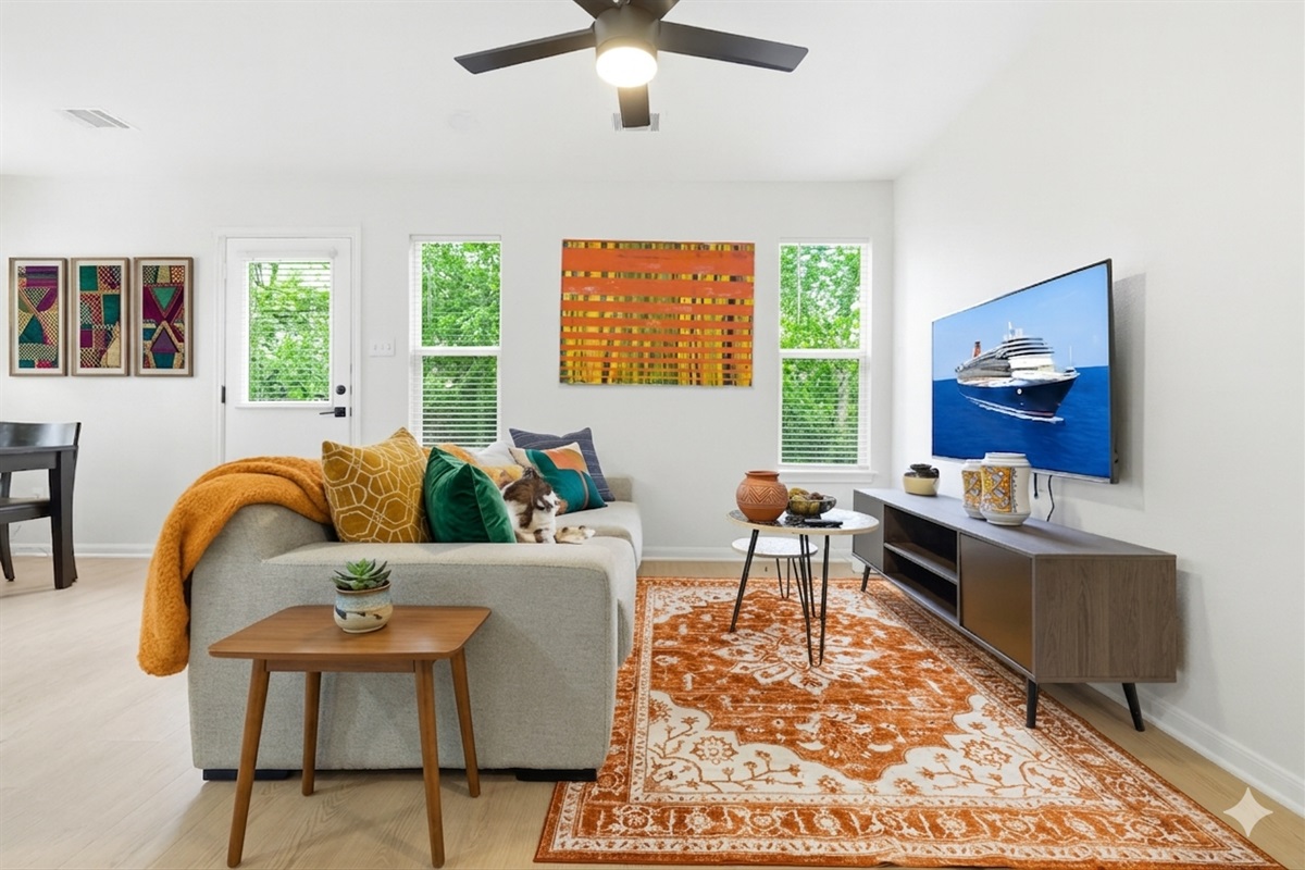 high end big couch very comfortable for group or family, with BIG TV, facing yard and trees