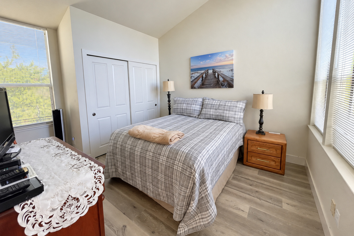 3rd Bedroom with Queen bed, vaulted ceilings and 3 large picture windows. Lots of natural lighting.