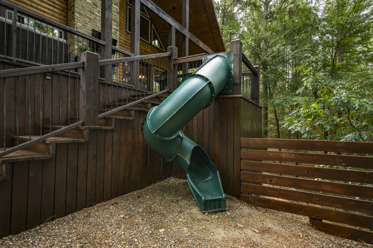 Your Hochatown getaway just got more fun — private cabin slide for endless outdoor play