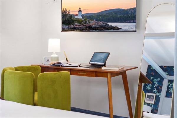 A cozy bedroom featuring a dedicated workspace, thoughtfully designed for comfort and productivity in a peaceful setting.