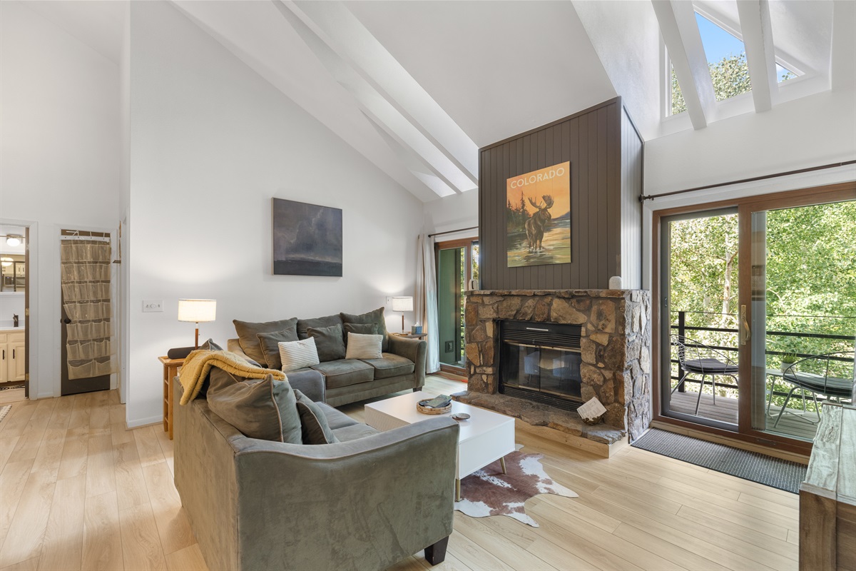 Living room with electric fireplace, 65" TV, private deck