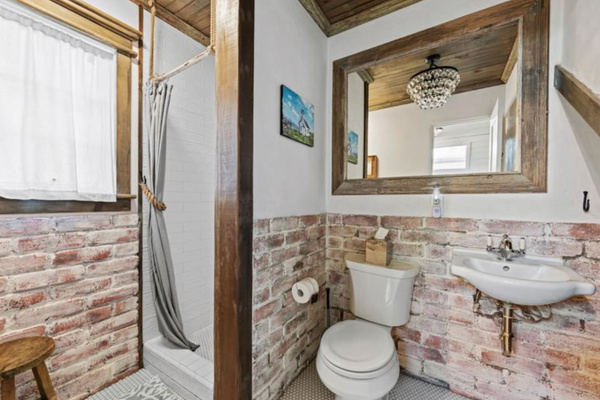 Brick and a little chandelier sparkle give the main-floor bathroom its charm. Nice eco shampoo, conditioner, and body wash provided. Fantastic water pressure. 