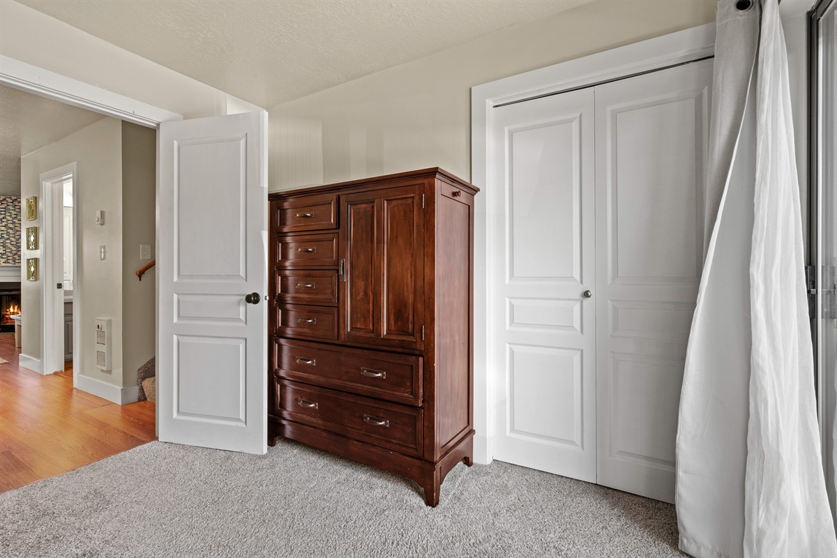 Spacious storage in bunk room with dresser and large closet.