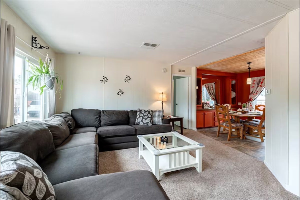 Bright, welcoming family room with comfy sectional and ample seating.