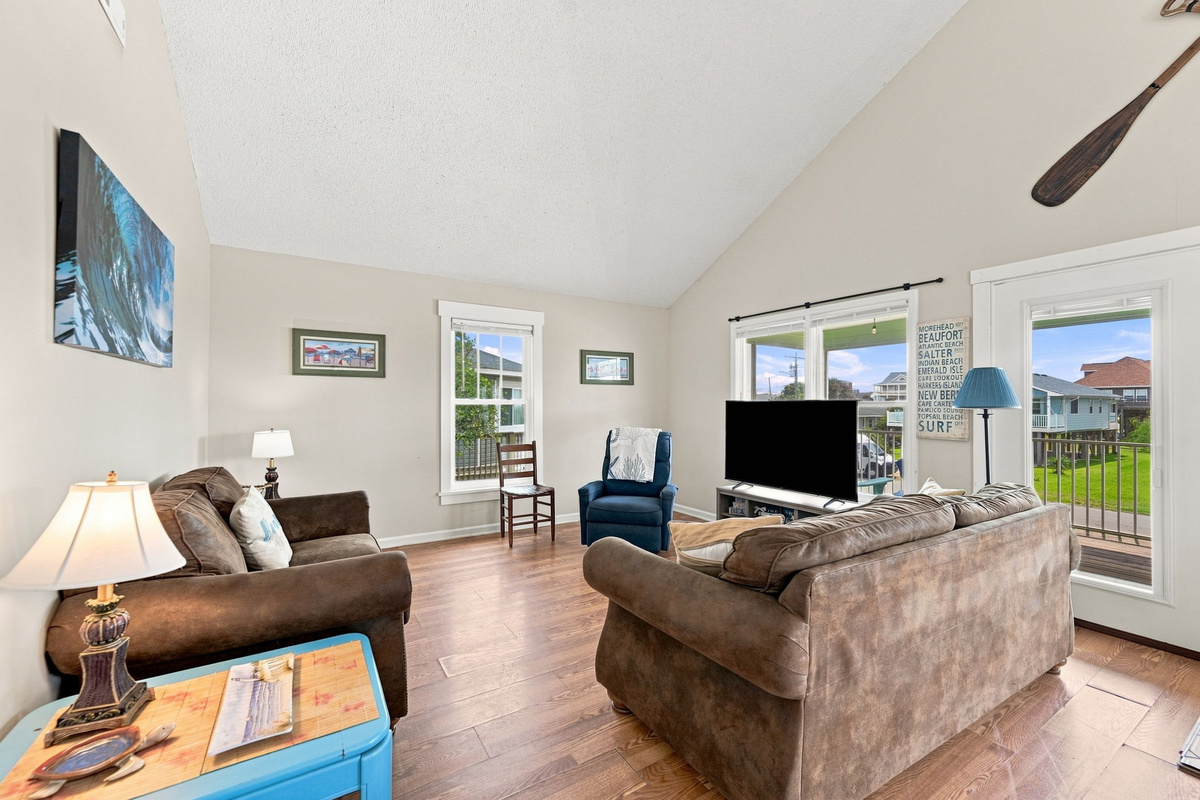 Gather, relax, and reconnect in the bright open living room with comfortable seating, Smart TV, and easy access to the deck