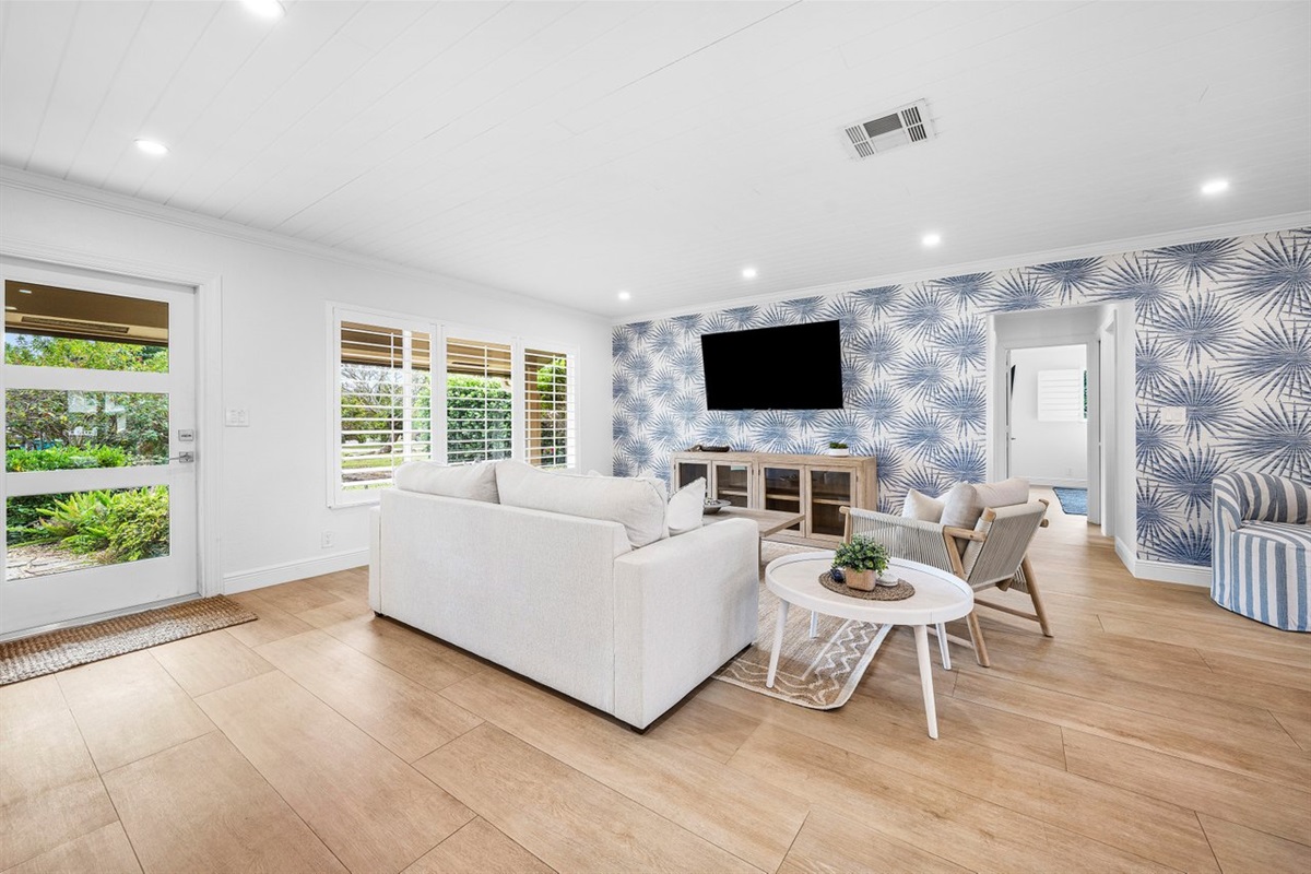 Tropical views and tranquil interiors come together in this inviting living room, where every detail is curated for comfort and sophistication.