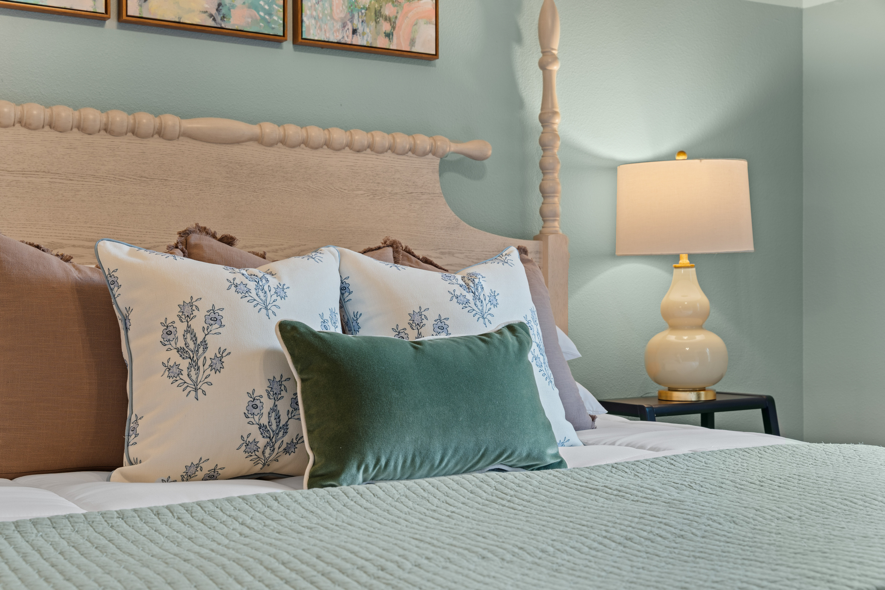 A turned-wood bed, gourd lamp, and sage walls keep the Galveston Room calm and cozy.