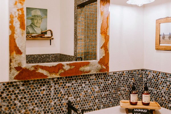 En-suite Bath #1 pairs exclusively with the first king bedroom &mdash; mosaic Hill Country tile, a vanity, and real privacy. No shared baths here.