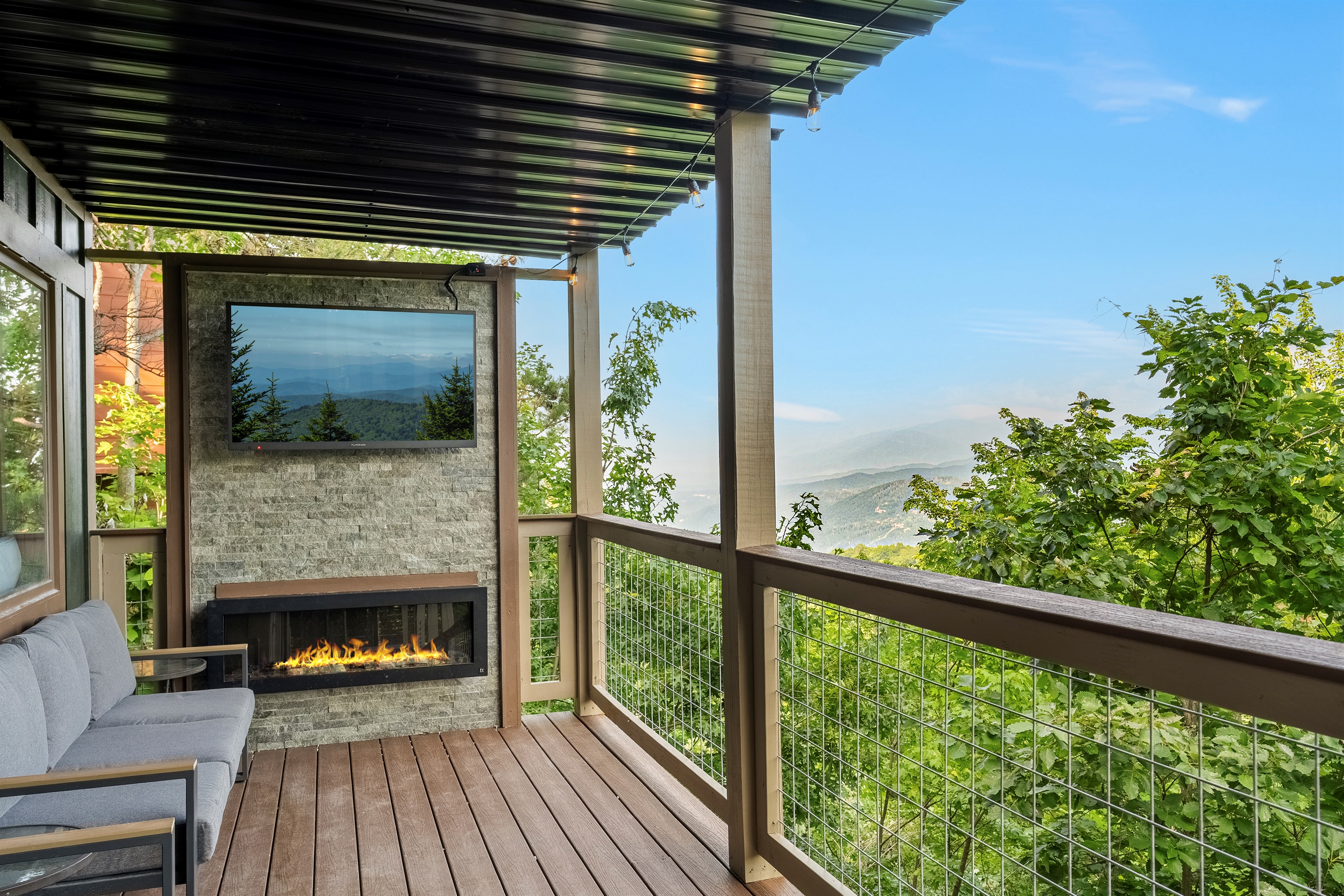 Beautiful outdoor electric fireplace and TV with views for miles!