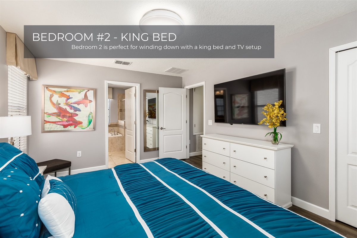 Comfort meets convenience in Bedroom 2 with a king size bed and a mounted TV
