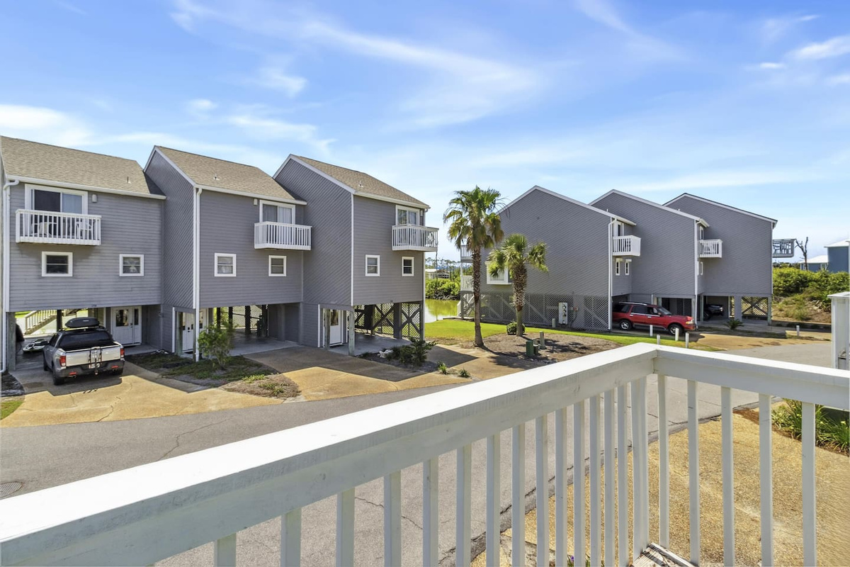 Step onto the guest balcony for a private moment of fresh coastal air and neighborhood views.