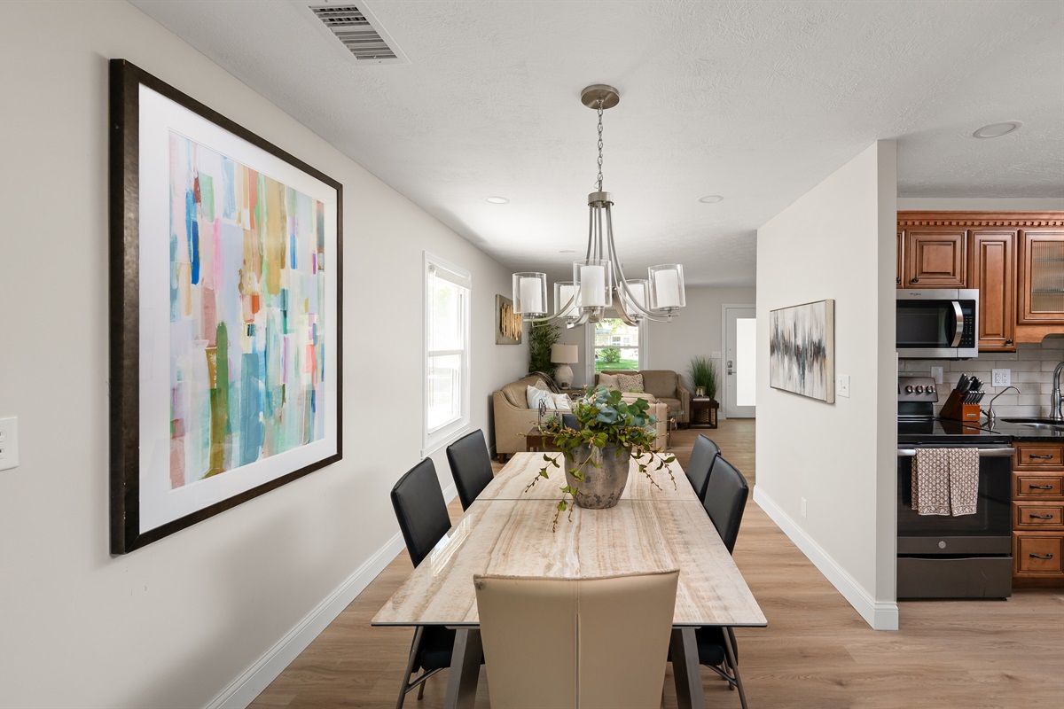 Dining area with seating for 6 conveniently opens to the kitchen and living room, making meals and gatherings easy and enjoyable.