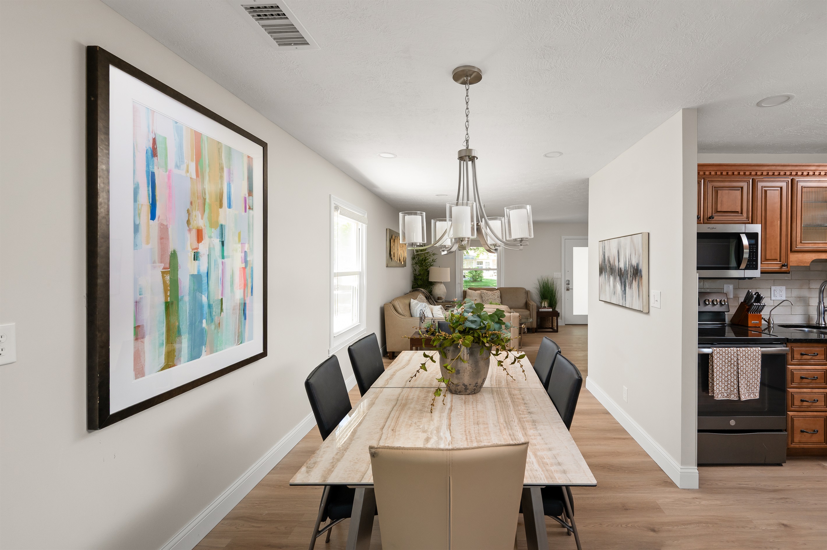 Dining area with seating for 6 conveniently opens to the kitchen and living room, making meals and gatherings easy and enjoyable.