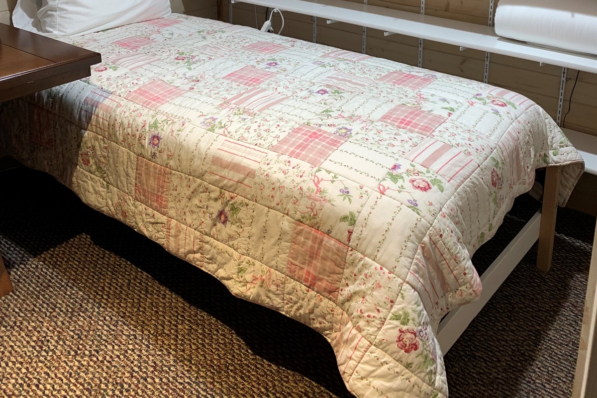 Twin bed in basement office area