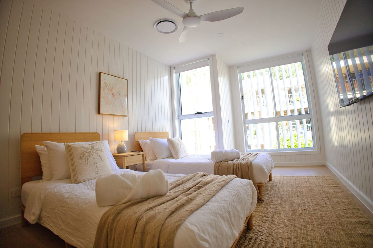 bedroom number 3. 2 king single mattresses with a 4k smart tv in the room