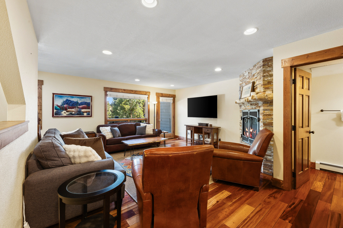 Spacious living room with plenty of room and seating for your entire group with attached half bath shown on right side. 